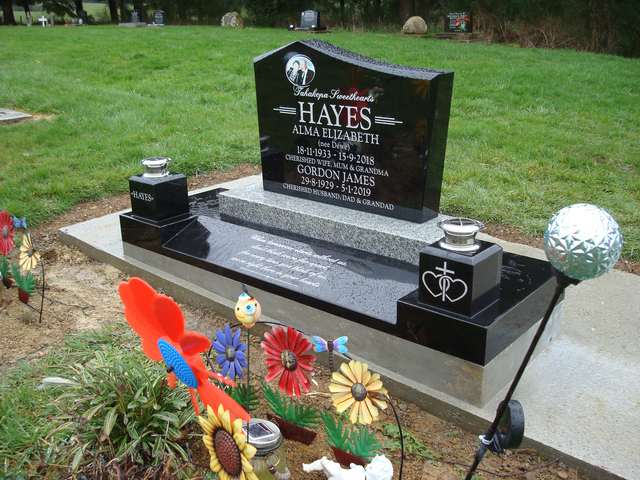 Polished black granite memorial after a full site cleaning